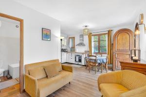 a living room with a couch and a table at Le Domaines Des Thermes - T2 in Gap +20 photos