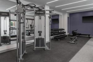 a gym with several treadmills and weights at Doubletree By Hilton Midland West Loop I-250 in Midland