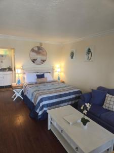 a bedroom with a bed and a blue couch at Sunset Cove - Water View in Sarasota +48 photos