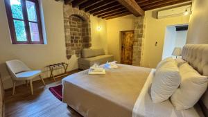 a bedroom with a large bed in a room at Avalon Boutique Hotel Rhodes in Rhodes Town