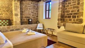 a room with a bed and a chair in it at Avalon Boutique Hotel Rhodes in Rhodes Town
