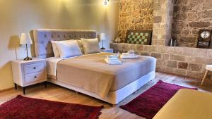 a bedroom with a large bed with towels on it at Avalon Boutique Hotel Rhodes in Rhodes Town +60 photos