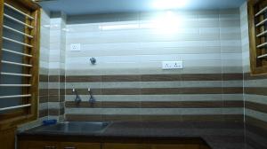 a bathroom with a sink and a tiled wall at Moon Hug Boutique Beach House in Auroville +14 photos