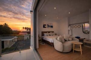 a bedroom with a bed and a couch and a balcony at The Samui Villa Retreat in Ban Bang Po +106 photos