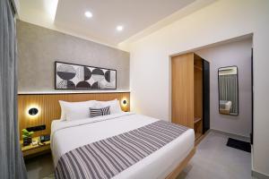 a bedroom with a large bed in a room at Olive Hotel Nagawara by Embassy Group in Bangalore +73 photos