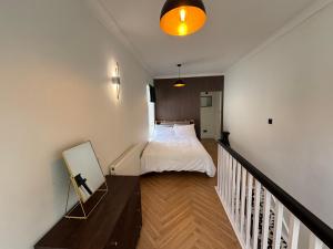 a small bedroom with a bed and a staircase at Peaceful Self-Contained Apartment in Beckenham