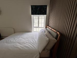 a bedroom with a bed in front of a window at Peaceful Self-Contained Apartment in Beckenham
