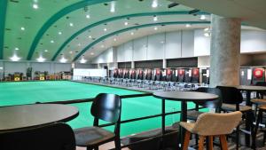 a pool in a gym with tables and chairs at Barrack Point Holidays in Barrack Point