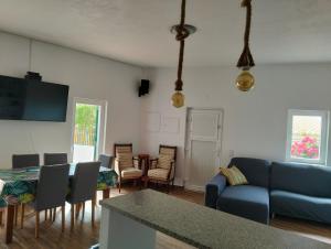 a living room with a blue couch and chairs at Casa da Boa Vista in Bordeira