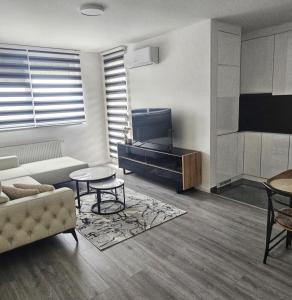 a living room with a couch and a tv at Nora in Žepče