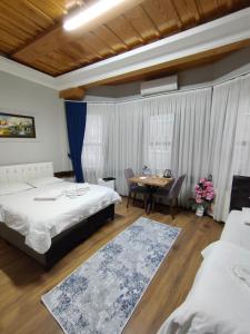 ein Hotelzimmer mit zwei Betten und einem Tisch in der Unterkunft Kule Pansiyon in Bursa