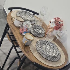 a wooden table with plates and glasses on it at Nora in Žepče