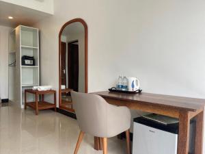 a room with a table and a chair and a mirror at Minah bungalows in Nungwi