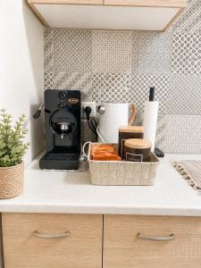 a kitchen counter with a coffee maker in a basket at Panorama View in Kalamata