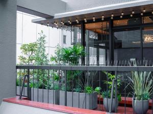 a building with plants on the side of it at SHIFT HOTEL Shibuya Jinnan in Tokyo