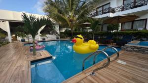 a rubber duck in the middle of a swimming pool at Minah bungalows in Nungwi