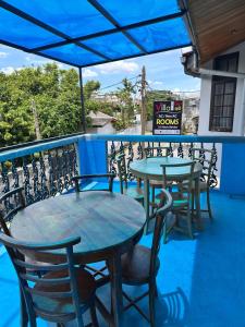 two tables and chairs on the balcony of a restaurant at Villa i in Dehiwala