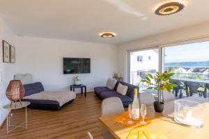 a living room with a couch and a table at Ferienhaus Aura in Bodman-Ludwigshafen