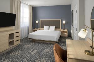 a hotel room with a bed and a flat screen tv at Hampton Inn & Suites Montgomery-Downtown in Montgomery +35 photos