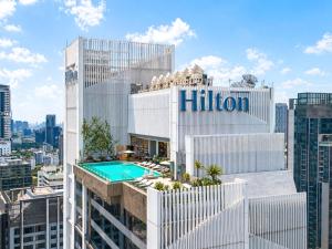 a view of the hilton hotel with a swimming pool at Hilton Sukhumvit Bangkok in Bangkok