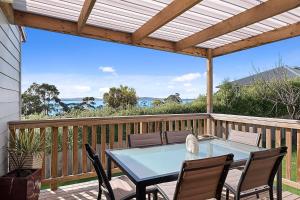 een terras met een tafel en stoelen bij Mirramar House in Kingston Beach