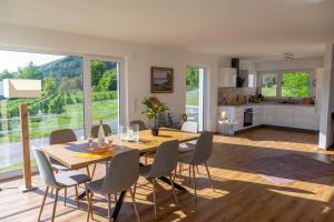 a dining room and living room with a table and chairs at Ferienhaus Aura in Bodman-Ludwigshafen