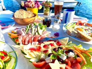 a table with plates of food on top of it at Villa Csery 1stzime in Supetarska Draga