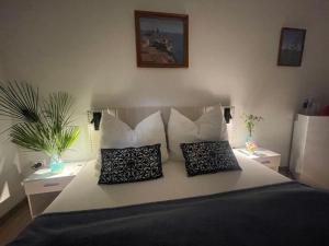 a bedroom with a large bed with two pillows at Villa Csery 1stzime in Supetarska Draga