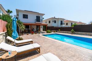 a villa with a swimming pool and a house at 4 Bedroom Villa With Private Pool in Maroni +45 photos