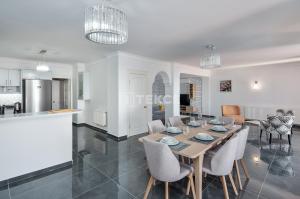 a dining room and kitchen with a table and chairs at TEKCE Villa Motto N21 in Kaş