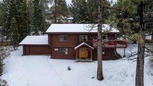 a log cabin in the snow with a porch at Modern Log Home-Walk2Slopes&Trails-Spa-Arcade-EVch in Big Bear Lake