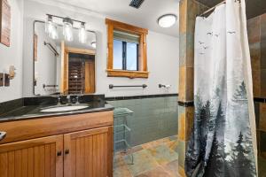 a bathroom with a sink and a shower at Modern Log Home-Walk2Slopes&Trails-Spa-Arcade-EVch in Big Bear Lake +48 photos