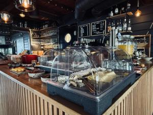 a bar with a counter with food on it at Lødingen Brygge in Lødingen
