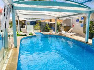 a swimming pool with a canopy over it at המקום של ברקו in Me‘ona