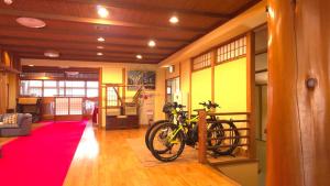 a bike parked in a room with a red rug at Samurai Hotel Naraiso in Narai