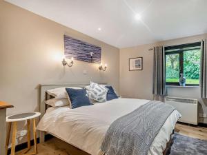 a bedroom with a large bed and a window at 3 Bed in Isle Of Arran oc-93240 in Pirnmill