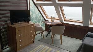 a room with a desk and a tv and a window at Happy beach in Varna City