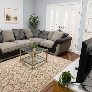 a living room with a couch and a coffee table at The Range Nestled Nook in Manchester