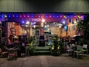a restaurant with tables and chairs and purple lights at 75 StangStay & Cafe de Art in Ka Rorn