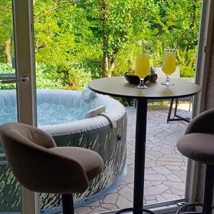 a patio with a table and two glasses of orange juice at VA vikendica Tesanj in Tešanj