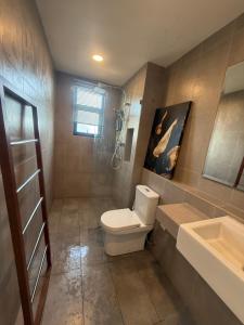 a bathroom with a toilet and a sink at Ecosea Timurbay in Kampong Tanjong +9 photos