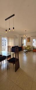 a living room with a table and chairs and a couch at Modern Secured Condo Apartments 1 in Tema