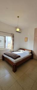 a large bed in a room with a window at Modern Secured Condo Apartments 1 in Tema