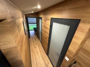 an open door in a room with wooden walls at Domek Przy Jeziorze in Kujanki