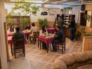 a group of people sitting at tables in a restaurant at Hotel Jousef in Puquio