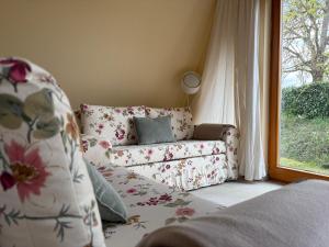 a living room with a couch and a window at Giebelblick Barweiler in Barweiler