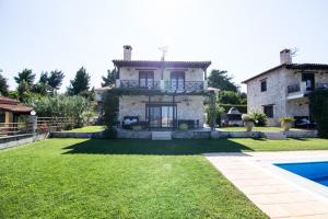 an image of a villa with a swimming pool at Jenny Villas in Kriopigi