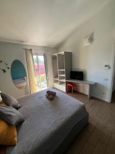 a bedroom with a bed with a teddy bear on it at Vele Storiche Pisane - free private parking in Pisa