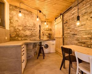 a kitchen with wooden walls and a table with chairs at Blaue Wohnung - Goldenes-Häusle in Sulzbach an der Murr
