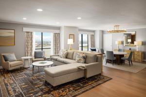 a living room with a couch and a dining room at Hilton New Orleans Riverside in New Orleans